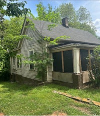 an old house in the middle of a wooded area
